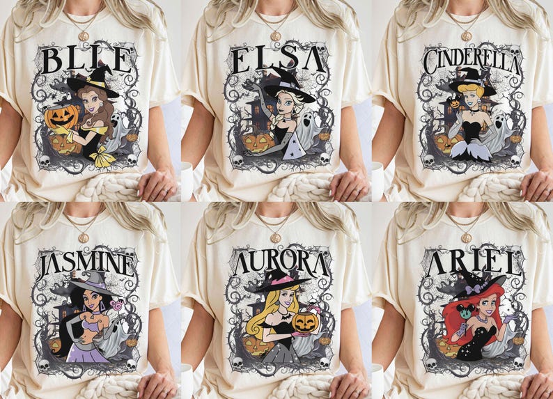 May include: A cream-coloured t-shirt featuring six distinct graphic designs of animated characters wearing witch hats. Each design includes a character name, such as Belle, Elsa, Cinderella, Jasmine, Aurora, or Ariel, surrounded by pumpkins, ghosts, and thorny vines.