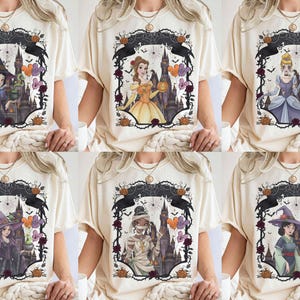 May include: A collection of six cream-coloured t-shirts, each featuring a different illustrated character in a gothic frame. The designs include characters dressed as a witch, a princess, and a mummy, set against a dark castle background with pumpkins.