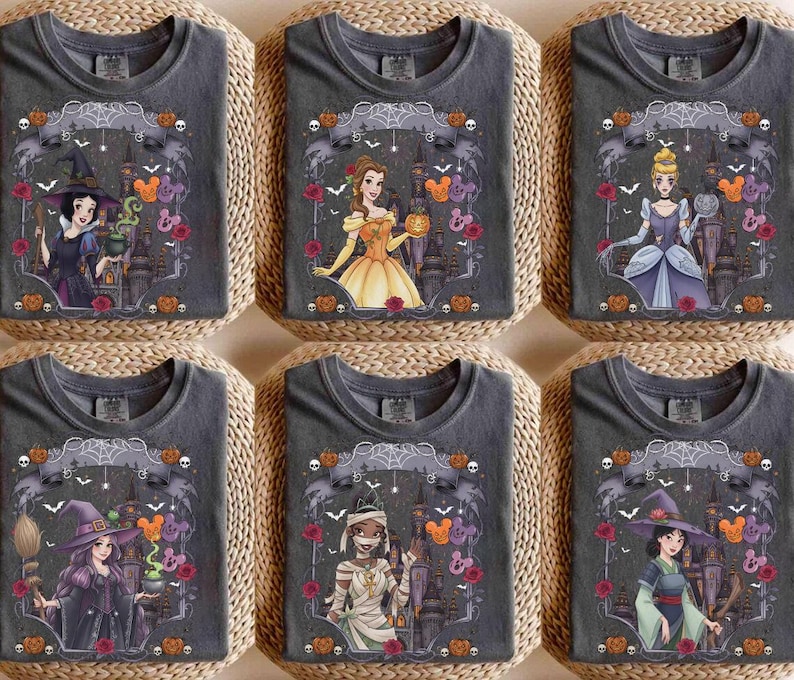 May include: Six charcoal grey t-shirts featuring various animated characters in Halloween costumes. Each shirt displays a unique character, including a witch, a princess, and a mummy, surrounded by pumpkins, spiderwebs, and castle silhouettes.
