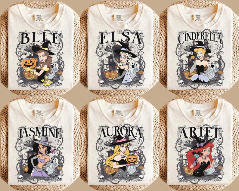 May include: Six off-white t-shirts featuring graphic prints of cartoon characters dressed as witches for Halloween. Each shirt displays a character name, including Belle, Elsa, Cinderella, Jasmine, Aurora, and Ariel, surrounded by spooky vines, ghosts, and pumpkins.