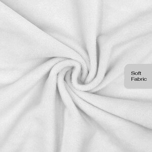 May include: A white fabric with a plush, fuzzy texture gathered in a central swirl. A light gray rectangular label is positioned on the right side of the image, featuring the black text Soft Fabric printed in a clean, sans-serif font.