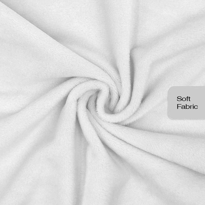 May include: A white fabric with a plush, fuzzy texture gathered in a central swirl. A light gray rectangular label is positioned on the right side of the image, featuring the black text Soft Fabric printed in a clean, sans-serif font.