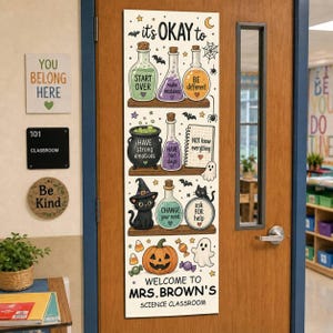 May include: A vertical rectangular door sign featuring the text 'it's OKAY to' above three shelves holding potion bottles, a cauldron, a cat, and a pumpkin. The sign includes the text 'WELCOME TO MRS. BROWN'S SCIENCE CLASSROOM' at the bottom.