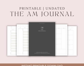 Peut inclure: Un journal imprimable et non daté intitulé "The AM Journal" avec une couverture gris foncé et des pages intérieures blanches. Le texte de la couverture comprend "Agenda for Yearly Goal Setting" et "With Productivity Habits Backed by Science."