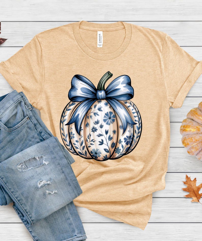 “Pumpkin Season shirt in soft cream, cozy fall graphic design.”