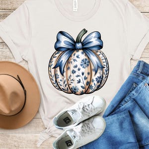 “Pumpkin Season graphic T-shirt in ivory, cozy fall design with pumpkins, unisex fit.”