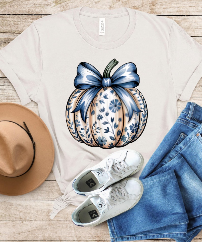 “Pumpkin Season graphic T-shirt in ivory, cozy fall design with pumpkins, unisex fit.”