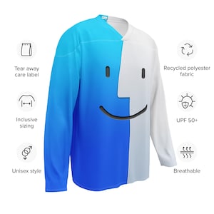 May include: A long-sleeved jersey with a split design. One side is white, the other is blue with a gradient. A black smiley face is on the white side. Features include recycled polyester fabric, UPF 50+, and breathable material. The jersey is unisex.