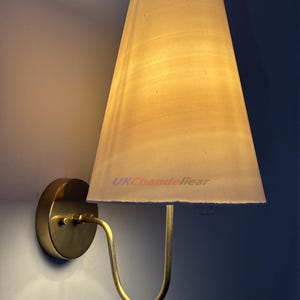 Aged Brass Wall Sconce with Fabric Shade: Vintage Minimalist Lighting