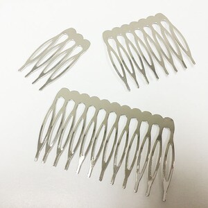 May include: Three silver-colored hair combs on a white background. The combs have a series of teeth and a curved design. The largest comb has 10 teeth, while the smaller combs have fewer.