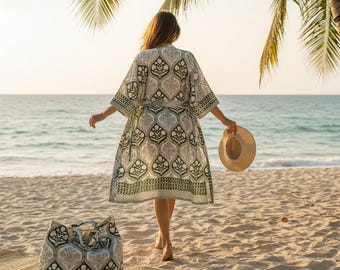 May include: A knee-length kimono robe featuring a repeating dark green and grey botanical pattern on a white background, with wide sleeves and a matching tie belt, accompanied by a large, structured tote bag with the same matching print.