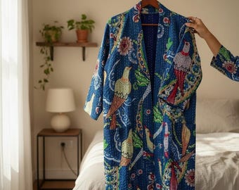 May include: A long-sleeved, open-front robe in deep blue, featuring a vibrant kantha-stitched pattern of various birds and floral motifs in shades of yellow, red, green, and white. The garment has a shawl collar and two front patch pockets.