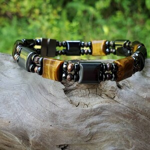 May include: A double-strand bracelet with brown tiger's eye and black hematite beads.