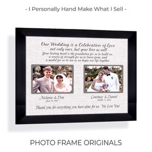 May include: A black framed wall art piece featuring a textured off-white background with two rectangular photo inserts. The text reads: Our Wedding is a Celebration of Love, Melanie & Don June 18, 1984, Courtney & Daniel October 12, 2026, and Thank you for everything you have done for us. We Love You!