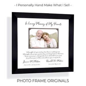 May include: A black square frame containing a memorial print with a central photograph of an older couple. The text reads In Loving Memory of My Parents, a poem, and the names Janice M. Matson and Ronald N. Matson with their respective dates.