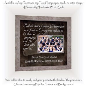 May include: A square framed wall art piece featuring a light gray wood-grain frame. The dark background displays a megaphone graphic and the text: Behind every fearless Cheerleader is a fearless Coach who refused to let them be anything but the best they can be. Thank You Coach Rachel 2024-2025 New Albany Cheer Team. A rectangular photo mat is centered, showcasing a group of cheerleaders in black uniforms.