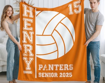 May include: An orange blanket with a white volleyball design. The blanket displays the name "HENRY", the number "15", and the text "PANTERS SENIOR 2025" in white. The blanket is held by two people.