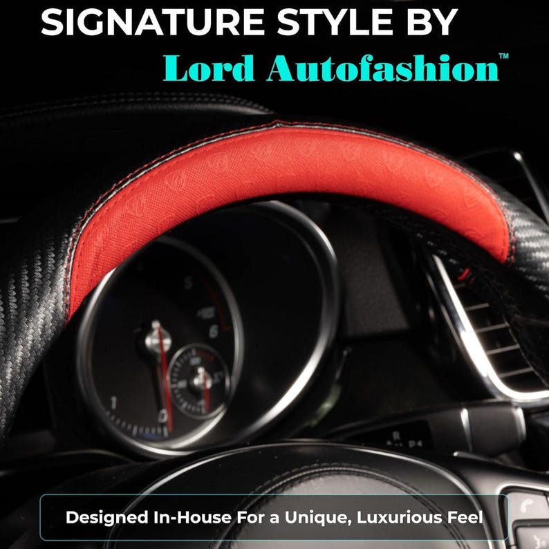 May include: Black and red steering wheel cover with the text "SIGNATURE STYLE BY Lord Autofashion". The cover has a carbon fiber design with a red top section. The text "Designed In-House For a Unique, Luxurious Feel" is also visible.