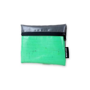 May include: A small, rectangular pouch with a green body and a gray top. The pouch has a black zipper and a small black tag that reads "sourced". The pouch is likely used for carrying small items.