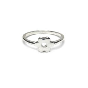 May include: A polished silver ring featuring a central flower-shaped motif with a circular cutout in the middle. The interior of the band is clearly stamped with the text 925, indicating the silver content of this simple and elegant jewellery piece.