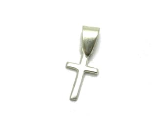 May include: A small, polished silver-toned cross pendant featuring a simple, clean design with straight edges and a tapered bail at the top for attachment to a chain. The metal surface has a smooth, reflective finish that catches the light.
