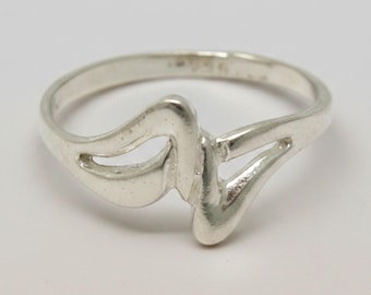 May include: A polished silver ring featuring a continuous, fluid, and abstract wave-like design that forms an open, asymmetrical shape across the top. The band is smooth and rounded, with the hallmark 925 clearly visible on the inner surface.