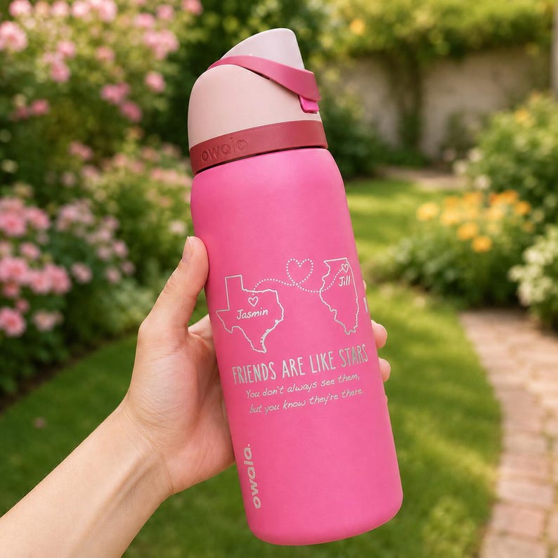 May include: A pink Owala water bottle with a light pink lid and a dark pink band. The bottle has the text "FRIENDS ARE LIKE STARS" and a graphic of two states connected by a heart. The bottle also has the names "Jasmin" and "Jill".