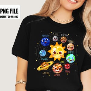 May include: Black t-shirt featuring a colorful cartoon illustration of the solar system, including the sun and planets. The text "PNG FILE INSTANT DOWNLOAD" is in the upper left corner. The planets are arranged in a circular pattern.