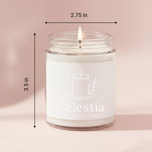 May include: A lit, white candle in a clear glass jar. The jar is 2.75 inches wide and 3.5 inches tall. The label reads "C&eacute;lestia" with a candle and leaf illustration. The candle is on a light pink background.