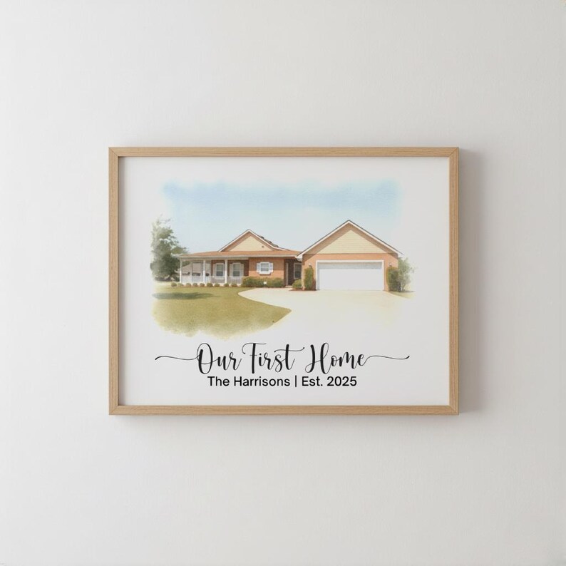May include: Watercolor painting of a house in a wooden frame. The house has a beige exterior, a garage, and a driveway. The text "Our First Home" and "The Harrisons | Est. 2025" are written in black script.