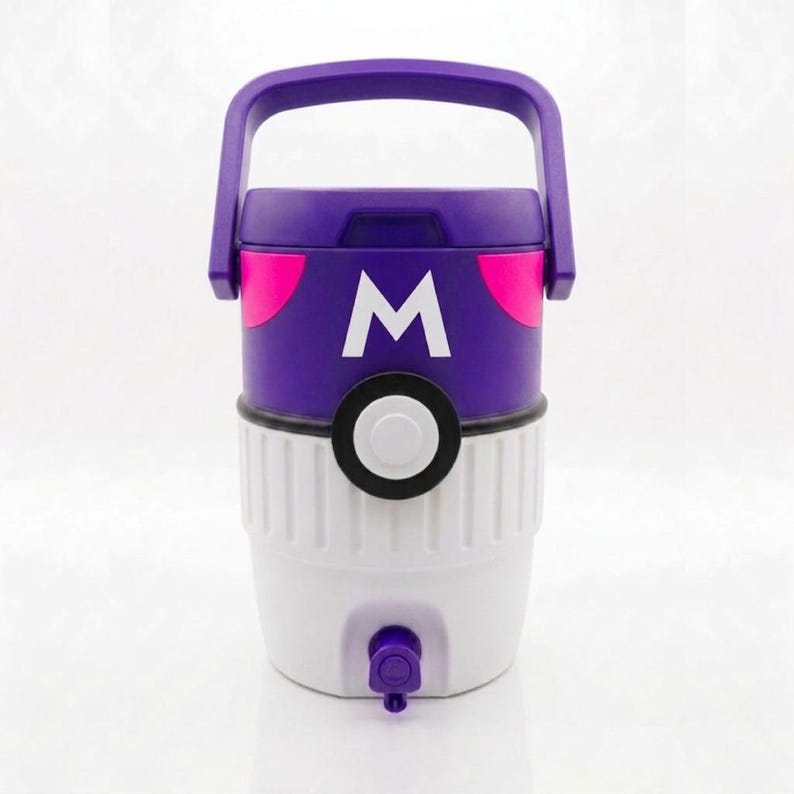May include: A purple and white cooler with a handle. The cooler has a purple lid with a white "M" and pink accents. The bottom half is white with a spigot. The cooler is designed to keep drinks cold.
