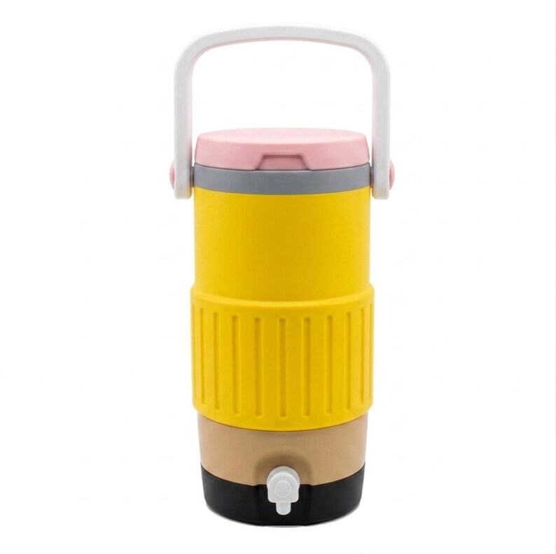 May include: A cylindrical beverage dispenser featuring a bright yellow body with a textured midsection, a light pink lid, and a white top handle. The base is tan with a black bottom section and a small white spigot centered at the front for pouring.