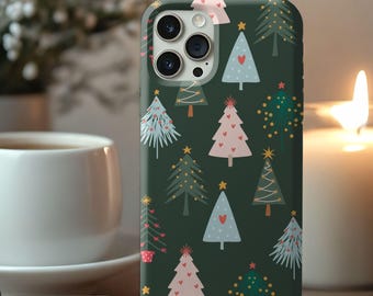 May include: A dark green phone case featuring a pattern of Christmas trees in various styles and colors, including pink, blue, and green. Some trees have heart and star accents. The text "more colors available" is at the bottom.