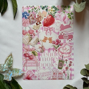 May include: A rectangular sticker sheet featuring a pink and white gingham background with various illustrations including a strawberry, cherries, books, bunnies, a swan, a matcha drink, and text that reads read more books and I'D RATHER BE READING.