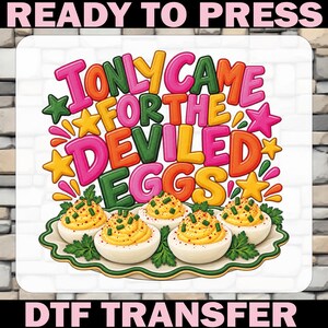 May include: A DTF transfer featuring the text I ONLY CAME FOR THE DEVILED EGGS in colorful bubble letters, surrounded by stars and a platter of four deviled eggs garnished with green herbs, with READY TO PRESS DTF TRANSFER text.