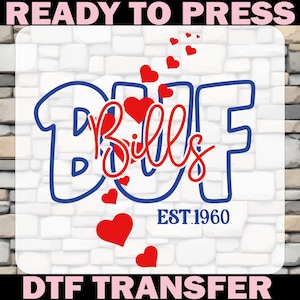 May include: A DTF (Direct to Film) transfer design featuring the word "Bills" in a script font, with red hearts and the text "EST.1960". The design is in blue and red, set against a white brick background. The words "READY TO PRESS" and "DTF TRANSFER" are at the top and bottom.