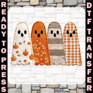 May include: A DTF transfer featuring four ghost-shaped figures with black eyes and mouths. The first is white with orange pumpkins, the second is orange with a floral pattern, the third is beige with horizontal stripes, and the fourth is orange gingham.