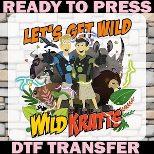 May include: A colorful DTF transfer featuring the text "READY TO PRESS" and "DTF TRANSFER". The design showcases the "Wild Kratts" cartoon characters with various animals and the phrase "LET'S GET WILD" in orange and yellow.