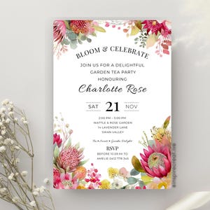 May include: A white invitation card with floral watercolor illustrations. The text reads "Bloom & Celebrate" and invites guests to a garden tea party honoring Charlotte Rose. The date is Saturday, November 21st.