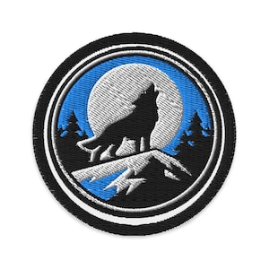 May include: Embroidered patch featuring a howling wolf silhouette against a full moon and pine trees. The design is set within a blue and black circular border, with a white outline. The patch is suitable for jackets, bags, or other fabric items.