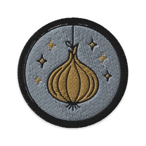 May include: Embroidered patch featuring a golden onion design with a light blue background and four gold stars. The patch has a black border and is circular in shape. The onion is detailed with textured stitching.