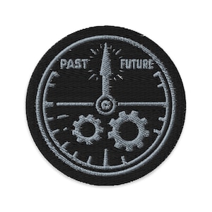 May include: Embroidered patch with a black background and a clock design. The clock features the words "PAST" and "FUTURE" with a clock hand pointing upwards. Two gears are visible at the bottom of the clock.
