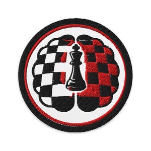 May include: Embroidered patch featuring a brain split into two halves. One half is a black and white checkerboard pattern, the other is red and black. A black chess king is in the center, with a red and black border.