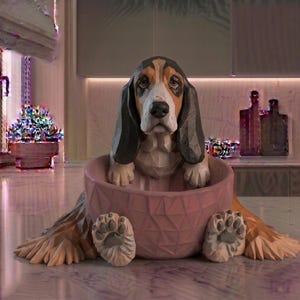 May include: A wooden sculpture of a Basset Hound dog sitting in a pink geometric bowl. The dog has brown, black, and white markings, with long floppy ears. The sculpture is detailed with paw prints and a textured bowl.