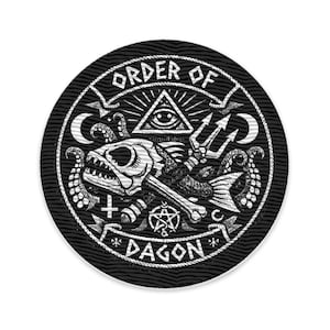 May include: Black and white embroidered patch with the text "ORDER OF DAGON". The design features a fish skeleton with a trident, an all-seeing eye, and other occult symbols. The patch is circular.