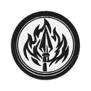 May include: Embroidered patch featuring a black and white design. The central image is a black spearhead surrounded by flames, set against a white background. The design is enclosed within a black circular border.