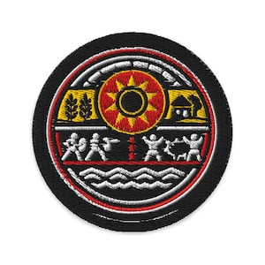 May include: Embroidered patch with a circular design featuring a central sunburst in red and yellow. The patch has a black background with white, red, and yellow accents, and includes stylized figures and symbols.