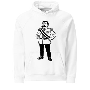 May include: White hoodie featuring a black and white illustration of a cartoon character in a military uniform. The character has a large mustache and is wearing a sash and medals. The hoodie has a kangaroo pocket and a drawstring hood.