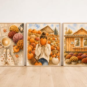May include: A set of three framed watercolour prints featuring autumn themes. The first shows a coffee cup and colourful mums, the second a person holding a pumpkin in a field, and the third a wooden farm stand with pumpkins and potted flowers.