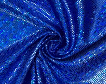 May include: Close-up of a blue iridescent fabric with a textured, shimmering surface. The fabric is folded and draped, showcasing its reflective qualities.